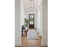 Entryway features wood flooring, bench, natural light, and a view of the front door at 417 Grove End Rd, Moncks Corner, SC 29461