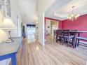 Open-concept home featuring a dining room with wood floors and an elegant chandelier at 5276 Copley Cir, Summerville, SC 29485