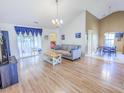 Spacious living room with vaulted ceilings, lots of natural light, and wood floors at 5276 Copley Cir, Summerville, SC 29485