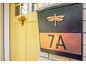 Close up of a yellow front door and mailbox with dragonfly decorations and '7A' address plate at 7 Chadwick Dr # A, Charleston, SC 29407