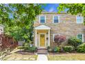 Charming home with a yellow brick exterior, covered front porch, and mature landscaping under a blue sky at 7 Chadwick Dr # A, Charleston, SC 29407