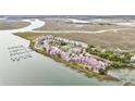 Luxury condos with amenities like tennis courts and swimming pools are surrounded by lush marshland at 74 Mariners Cay Dr, Folly Beach, SC 29439