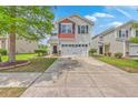 Inviting two-story home with a spacious driveway, lush lawn, and classic white siding at 9707 Seed St, Ladson, SC 29456
