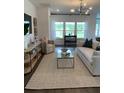 Bright and airy living room with stylish furniture, large windows, and a scenic view at 1032 Scotch Bonnet Way, Summerville, SC 29485
