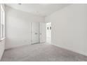 Bright bedroom with carpet, open closet with bi-fold doors, and a view into another room at 104 Hawthorne Landing Dr, Goose Creek, SC 29445