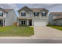 Charming two-story home featuring gray siding, black shutters, a two-car garage, and a well-manicured lawn at 114 W Bradford Pointe Dr, Summerville, SC 29483