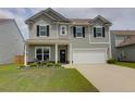 Charming two-story home featuring gray siding, black shutters, a two-car garage, and a well-manicured lawn at 114 W Bradford Pointe Dr, Summerville, SC 29483