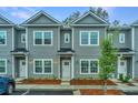 Gray townhome showcasing a tidy, landscaped frontage and inviting curb appeal at 1204 Twin Rivers Drive, Wando, SC 29492