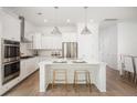 Modern, all-white kitchen with stainless steel appliances, quartz countertops, and a spacious center island at 126 Maritime Way, Summerville, SC 29485