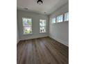 Bright, airy bedroom with hardwood floors and ample natural light from three large windows at 139 Summerwind Dr, Summerville, SC 29486