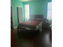 Bedroom with hardwood floors, bed and natural light at 14 Lockwood Dr # 1-F, Charleston, SC 29401