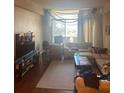 Bright living room with comfy seating, rug, and large window at 14 Lockwood Dr # 1-F, Charleston, SC 29401