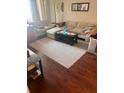 A cozy living room featuring an L-shaped sofa, soft rug, and dark wood flooring at 14 Lockwood Dr # 1-F, Charleston, SC 29401