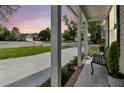 Inviting front porch showcasing neighborhood views and a comfortable sitting area at 1725 Henley Ln, Charleston, SC 29412