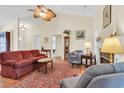 Spacious living room featuring a ceiling fan, fireplace, and warm natural light at 1725 Henley Ln, Charleston, SC 29412