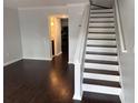 Inviting living room featuring dark hardwood floors and stairs at 1735 Boone Hall Dr # K6, Charleston, SC 29407