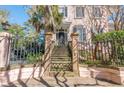 Charming home featuring a wrought iron gate and stairs leading to the front door with transom window at 192 Ashley Ave # C, Charleston, SC 29403