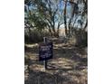 Sign to the private dock for homeowner use only near a wooded area with a path to the water at 2027 Riverbend Dr, Charleston, SC 29412