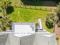 Aerial shot of a fenced backyard with a patio, lawn, and palm trees at 2107 Club View Ct, Charleston, SC 29412