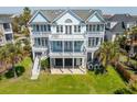 A spacious beach house with multi-level balconies offers stunning views from every angle at 2107 Club View Ct, Charleston, SC 29412
