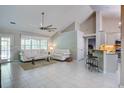 Bright living room featuring vaulted ceilings, tile flooring, and a seamless flow into a modern kitchen at 2154 Country Manor Dr Dr, Mount Pleasant, SC 29466