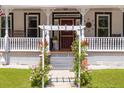 Inviting front porch with decorative pergola, classic railings, and well-maintained landscaping, steps to front door at 21785 Lowcountry Hwy, Ruffin, SC 29475