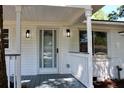 Inviting front porch with decorative railing, modern sconces, and a glass-paneled door, perfect for welcoming guests at 227 Amy Dr, Goose Creek, SC 29445