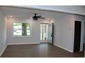 Bright living room featuring stylish gray walls, modern ceiling fan, and durable wood-look flooring at 227 Amy Dr, Goose Creek, SC 29445