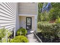 Welcoming front entryway with lush greenery, decorative touches, and a charming path, inviting you inside at 254 Cypress Marsh Rd, Moncks Corner, SC 29461