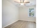 This bedroom features wood-look flooring and a window overlooking the outdoor scenery at 2606 Bennett Yard Rd, North Charleston, SC 29405