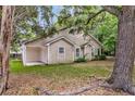 Backyard featuring mature trees, a cozy covered patio, and room for outdoor activities at 2919 Fernwood Dr, North Charleston, SC 29406