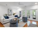 Open-concept living room with hardwood floors and elegant furniture; bright and airy at 3019 Fraserburgh Way, Mount Pleasant, SC 29466