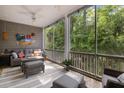 Relaxing screened-in porch with comfortable seating overlooking the serene wooded views at 3019 Fraserburgh Way, Mount Pleasant, SC 29466