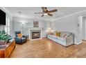 Cozy living room with hardwood floors, fireplace, and comfortable seating at 3084 Queensgate Way, Mount Pleasant, SC 29466