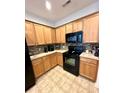 Well-equipped kitchen featuring sleek black appliances, light wood cabinets, and stylish backsplash at 310 Flyway Rd, Goose Creek, SC 29445