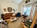 Cozy living room with a leather sofa, decorative decor, and an area rug over wood flooring at 310 Flyway Rd, Goose Creek, SC 29445