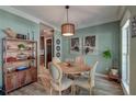 Stylish dining room with hardwood-style floors, modern lighting, and elegant decor at 3298 Heathland Way, Mount Pleasant, SC 29466