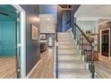 Elegant entryway with a staircase and views into the living room with hardwood style flooring at 3298 Heathland Way, Mount Pleasant, SC 29466