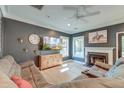 Comfortable living room featuring a fireplace, hardwood-style floors, and a ceiling fan at 3298 Heathland Way, Mount Pleasant, SC 29466