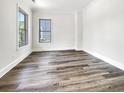 A bright bedroom with hardwood floors, two windows and white walls at 350 Oak Park St, Summerville, SC 29486