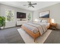 Serene bedroom with a ceiling fan, plush rug, neutral colors, and natural light from two windows at 350 Oak Park St, Summerville, SC 29486