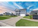 Beautiful exterior with a lush lawn and a convenient two-car driveway and mailbox at 424 Carrara Dr, Summerville, SC 29486