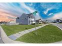 Corner lot featuring verdant lawn, a sidewalk, and clear street-name signage at 424 Carrara Dr, Summerville, SC 29486