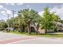 A home sits behind large palms and a brick-lined road, exuding charm at 4407 S Shirley Dr, North Charleston, SC 29418