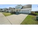 Attractive home with well-kept lawn, driveway leading to an attached two car garage at 490 Rowley Ln, Summerville, SC 29486