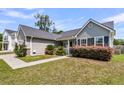 Well-maintained home with tidy lawn, landscaped shrubbery, and convenient walkway to the front door at 5376 Copley Cir, Summerville, SC 29485