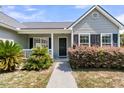 Welcoming front entrance featuring a cozy porch, neat landscaping, and classic window shutters at 5376 Copley Cir, Summerville, SC 29485