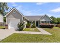 Attractive single-story home with a lush green lawn, integrated garage, and well-maintained front garden at 5376 Copley Cir, Summerville, SC 29485