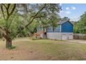 Shows the home's entrance and elevation of home on a garage and large yard at 5669 Sands Rd, Hollywood, SC 29449