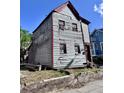Two-story residence shows weathered wood siding and a modest yard needing repairs at 6 Moultrie St, Charleston, SC 29403